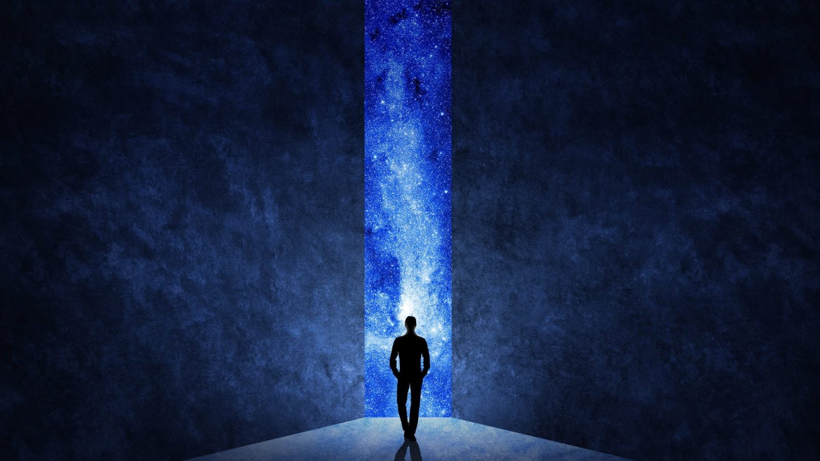 Man in front of open door with universe behind