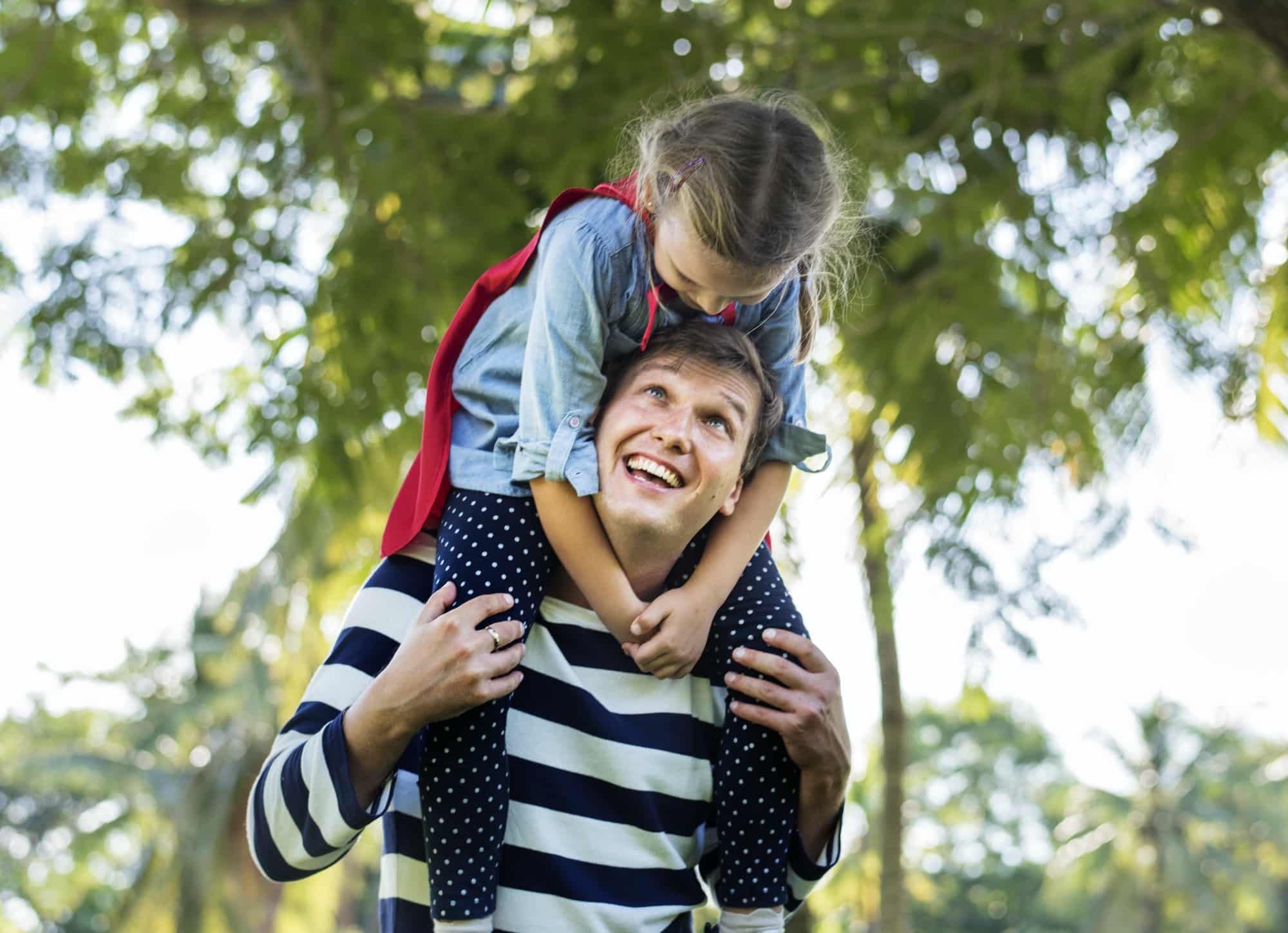 Father and daughter playing superheroes